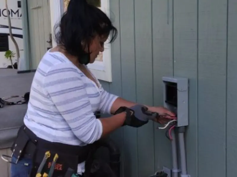 Licensed electrician wiring an exterior subpanel in South Point